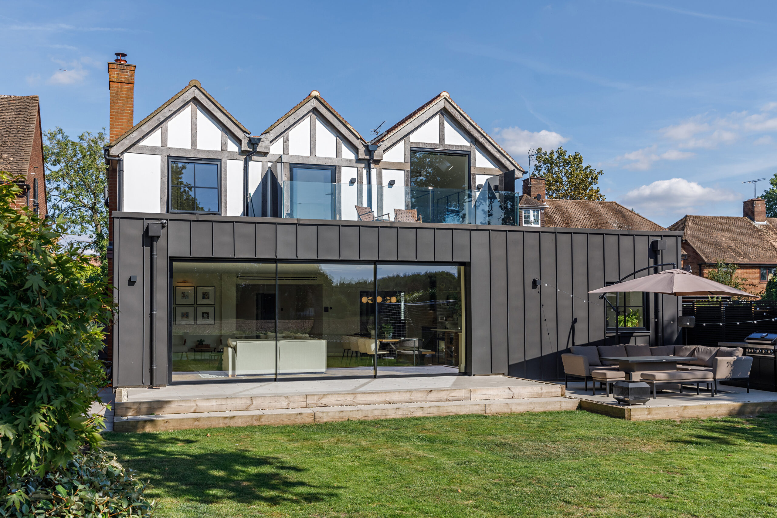 Pocket sliding doors disappearing into wall cavity, leaving a completely open aperture onto garden terrace