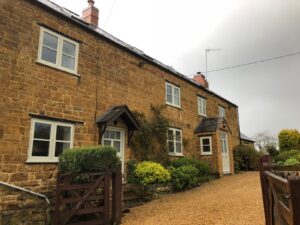 Timber-effect windows on a traditional Cotswolds cottage